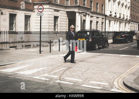 Business man is walking down the street in London, United Kingdom. Stock Photo