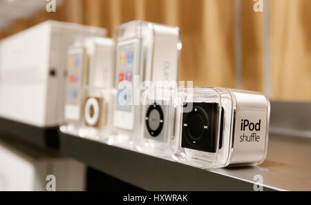 New iPod Shuffle and iPod Nano mp3 players stand on a shelf in an Apple store. Stock Photo