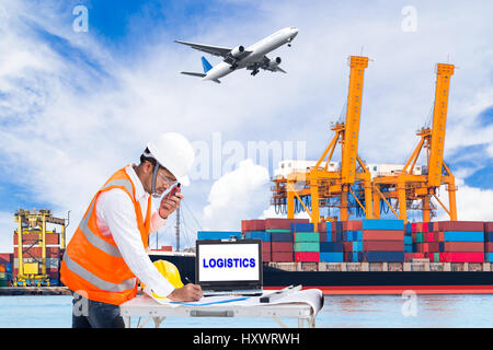 Engineer dockers talking on the walkie-talkie for controlling loading container and recording data in an industrial harbor for logistic Import export  Stock Photo