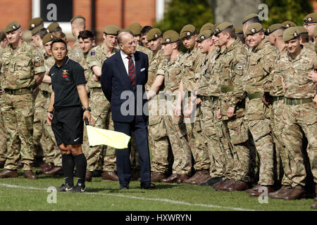 The Duke of Edinburgh, in his capacity of Colonel, Grenadier Guards, stands near the linesman as he talks to members of the 1st Battalion Grenadier Guards as they watch from the sidelines during the final few minutes of the Manchester Cup inter-company football match at Lille Barracks in Aldershot. Stock Photo