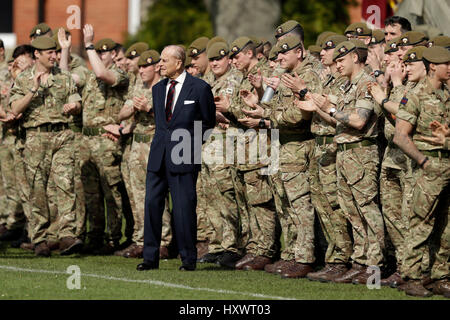 The Duke of Edinburgh, in his capacity of Colonel, Grenadier Guards, stands with members of the 1st Battalion Grenadier Guards as they applaud the final whistle from the sidelines, of the Manchester Cup inter-company football match at Lille Barracks in Aldershot. Stock Photo