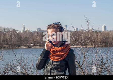 Young girl joyfully speaks on the phone Stock Photo