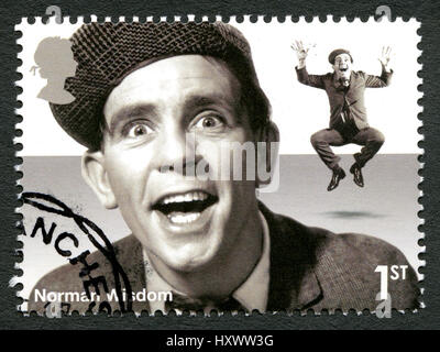 UNITED KINGDOM - CIRCA 2015: A used postage stamp from the UK, depicting a portrait of legendary British comedian and actor Norman Wisdom, circa 2015. Stock Photo