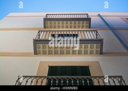 PALMA DE MALLORCA, BALEARIC ISLANDS, SPAIN - MARCH 29, 2017: Balconies with decorative floor tiles underneath detail in Palma Old Town on March 29, 20 Stock Photo