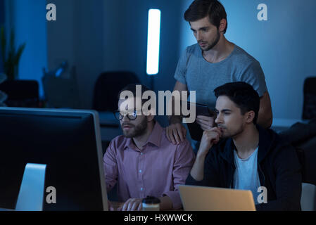 Intelligent handsome programmer working on the computer Stock Photo