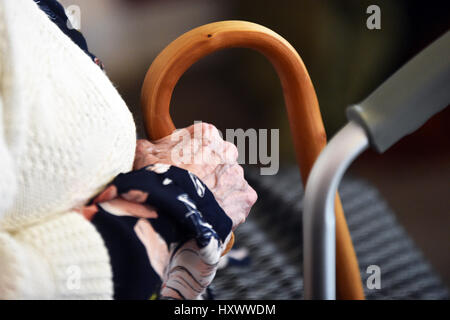 Close up of elderly ladies hand holding her walking stick in a care home, Yorkshire UK Stock Photo