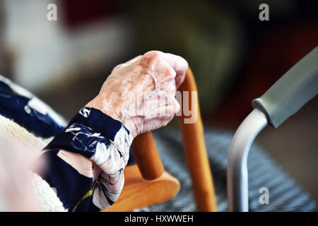 Close up of elderly ladies hand holding her walking stick in a care home, Yorkshire UK Stock Photo
