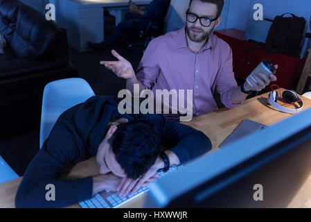 Nice tired programmer falling asleep Stock Photo