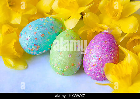 Easter eggs decorated with yellow daffodil flowers Stock Photo