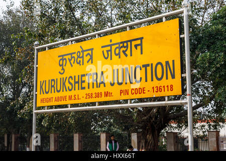 Typical yellow name sign on the platform at Kurukshetra Junction railway station platform, on the Delhi to Kalka line, Haryana, northern India Stock Photo