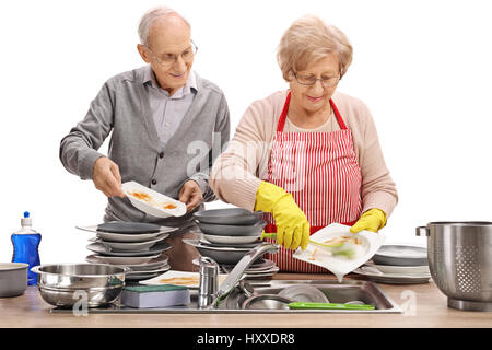 Elderly couple doing the dishes together isolated on white background Stock Photo