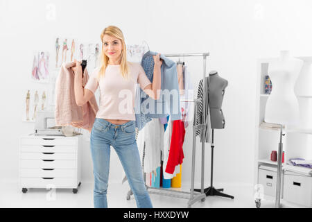 Customer  shopping discount clothing collection of a successful fashion designer in her showroom Stock Photo
