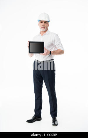 Mature male architect in hard hat showing digital tablet Stock Photo