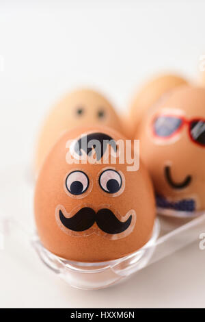 closeup of some easter eggs decorated with funny faces in a plastic egg tray Stock Photo