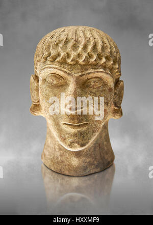 First half of the 6th century B.C Etruscan clay head of a young man made in Chiusi, inv 94612, National Archaeological Museum Florence, Italy , grey a Stock Photo