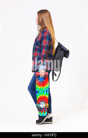 Studio portrait of young beautiful woman with skateboard isolated on white background. Stock Photo