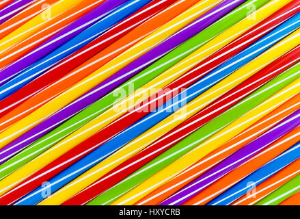 Background out of diagonally arranged vibrantly colored drinking straws forming interesting pattern. Stock Photo