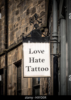 Love Hate Tattoo sign outside tattoo artist shop, Edinburgh, Scotland. Stock Photo