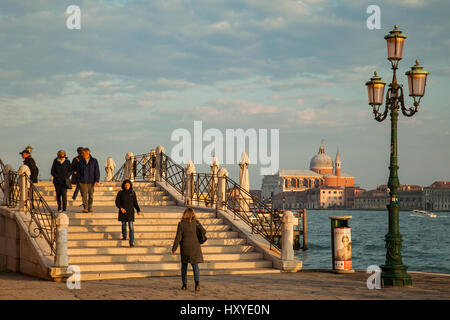 Sunset in Dorsoduro district of Venice. Santissimo Redentore church on Giudecca island in the distance. Stock Photo