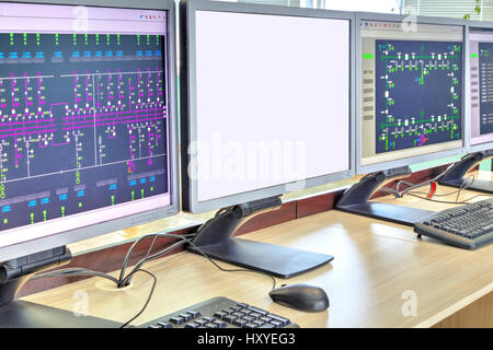 Computers and monitors with schematic diagram for supervisory, control and data acquisition in modern electrical control room Stock Photo