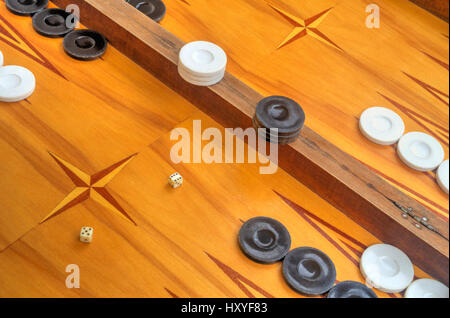 Wooden board for playing backgammon game with pools and dice Stock Photo