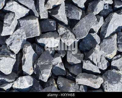 basalt stones close up an hard sunlight, striplight Stock Photo