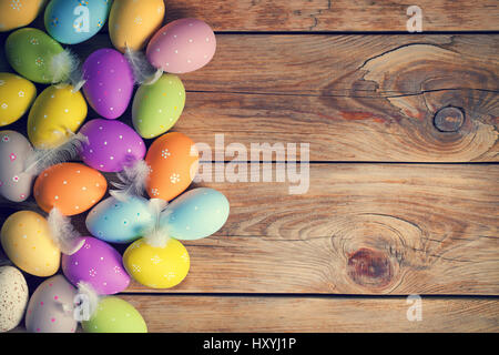 Easter background with Easter eggs on wooden table. Top view. Copy space Stock Photo