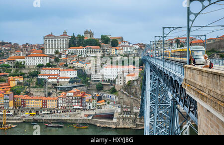 Portugal, Region Norte, Porto, a tram crosses the iconic Dom Luis I double-decked metal arch bridge over the River Douro, connecting Porto and Vila No Stock Photo