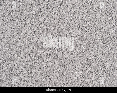 white painted wall with structural plaster closeup / macro in the sunlight Stock Photo