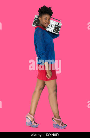 African Descent Woman Holding Jukebox Stock Photo