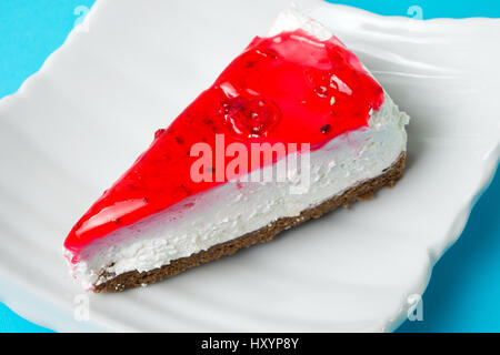 strawberry cheesecake slice on a white plate Stock Photo