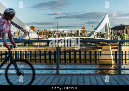 Glasgow Cyclist in Motion with Tradeston Bridge on River Clyde in the Background Stock Photo