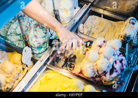 Hand Scooping Ice Cream in an Ice Cream Parlour Stock Photo
