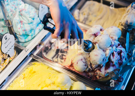 Hand Scooping Ice Cream in an Ice Cream Parlour Stock Photo