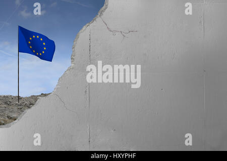 European Union flag behind a concrete wall. Stock Photo