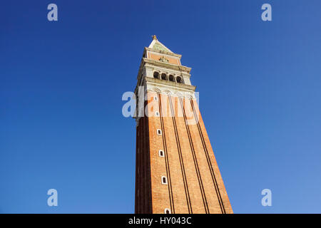 Hydraulic mobile construction platform elevated towards a blue sky with metal pole street lamp Stock Photo
