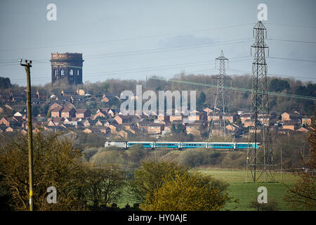 Arriva Trains Wales passing, on a Manchester to Wales service Norton Water Tower Cheshire, England. UK. Stock Photo
