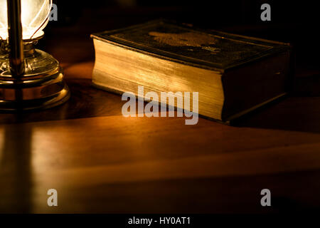 Bible in the light of an oil lamp. Stock Photo