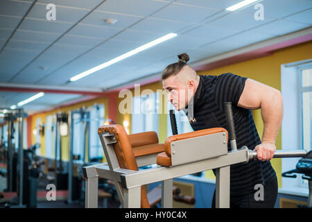 Focused man doing dips in the gym Stock Photo