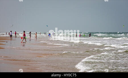 Beachgoers enjoying the Gulf of Mexico ocean waves and beach in South Padre Island, Texas Stock Photo