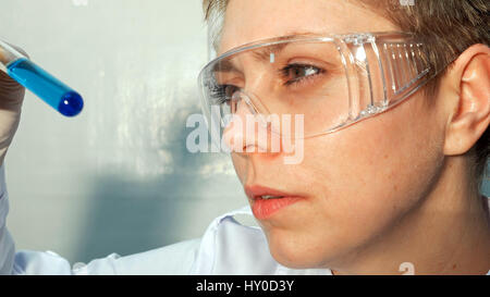 Doctor scientist looking at the test tubes in lab Stock Photo