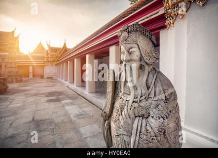 Stone statue of monk in Buddhist Temple Wat Pho in Bangkok, Thailand Stock Photo