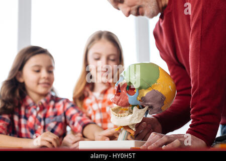 Active cute children engaged in educative process Stock Photo