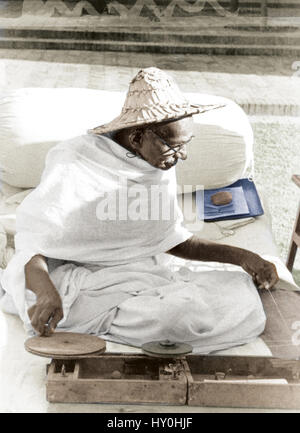 Mahatma gandhi spinning in garden of birla house, new delhi, india, asia, 1947 Stock Photo