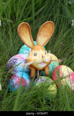 Colored easter eggs and rabbit on  green grass background Stock Photo