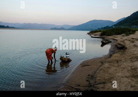 Tribal woman filling water pot from river water, papikondalu, andhra pradesh, india, asia Stock Photo