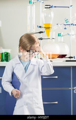 Little boy wearing lab coat in science laboratory Stock Photo