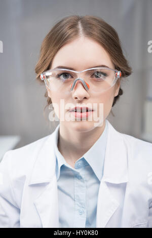Portrait of young professional female scientist in protective eyewear Stock Photo