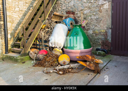 Collection of maritime objects, anchors,buoys, on a quay, Teignmouth, UK. Stock Photo