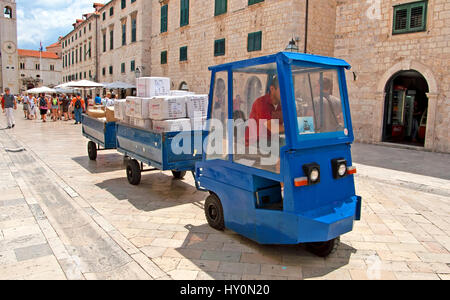 DUBROVNIK, CROATIA - JUNE 28, 2010: Train for transportation of parcels of the main street (Stradun or Placa), with locals and tourists in Dubrovnik Stock Photo